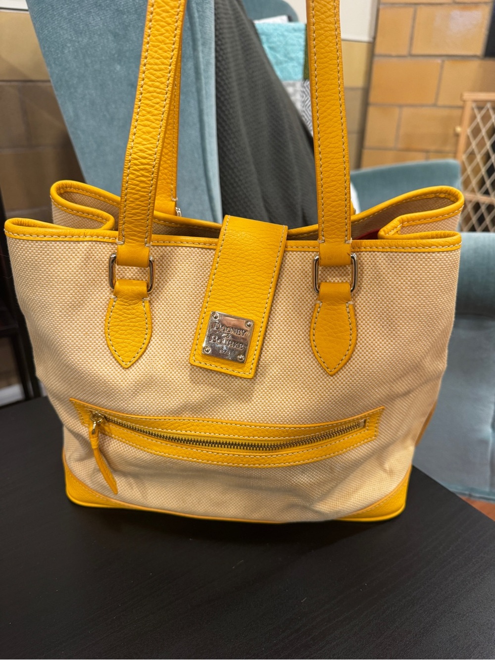 Dooney & Bourke sunflower tote in cream canvas with yellow leather trim.
